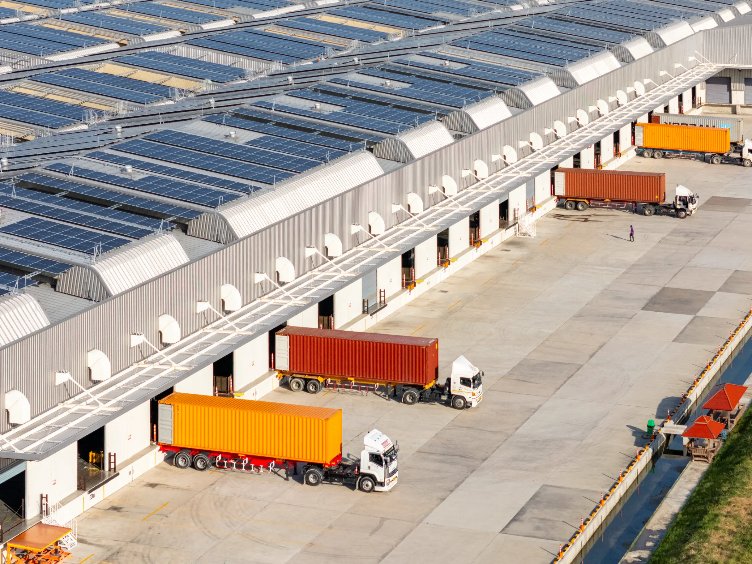 Modern Logistic Center with Trucks and Solar Panels on the Roof
